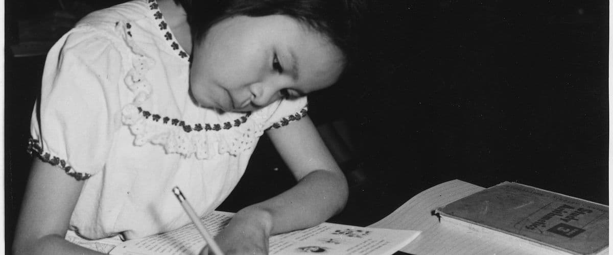 A student writing in a book